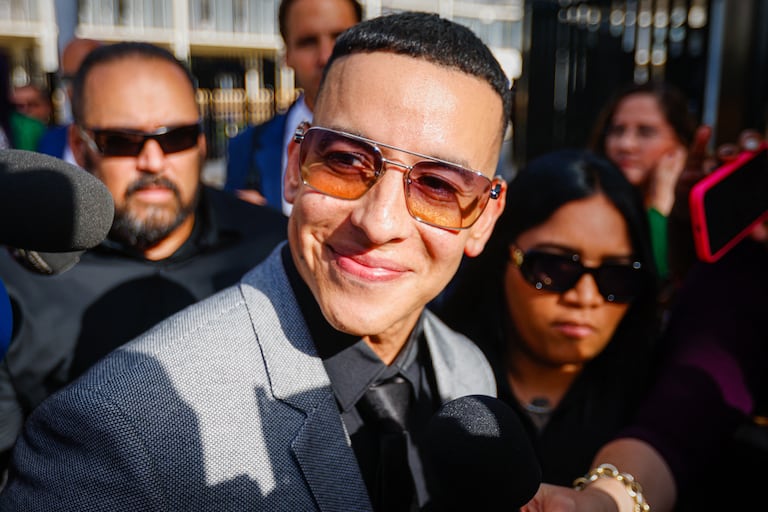 Daddy Yankee speaks to the media as he leaves the United States Federal Court for the District of Puerto Rico following a hearing in San Juan, Puerto Rico, on August 14, 2025. The rapper appears in court after filing a lawsuit against his ex-wife, Mireddys Gonzalez, and his former sister-in-law, Ayeicha Gonzalez, alleging they delete important information from the companies El Cartel Productions and Los Cangris Inc., seeking $12 million in damages. (Photo by Edgardo Medina/NurPhoto) (Photo by Edgardo Medina / NurPhoto via AFP)