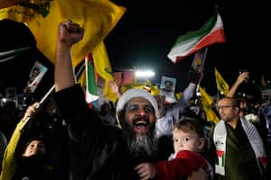 A cleric clenches his fist as he celebrates Iran's missile strike against Israel in an anti-Israeli gathering at Felestin (Palestine) Sq. in Tehran, Iran, Tuesday, Oct. 1, 2024. (AP Photo/Vahid Salemi)