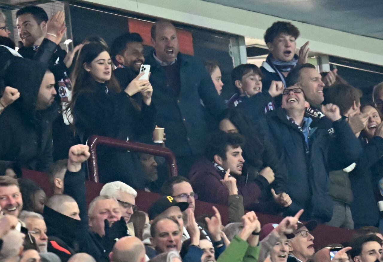 Britain's Prince William, Prince of Wales, and Prince George celebrate after Villa's second goal during the UEFA Champions League quarter-final second-leg football match between Aston Villa and Paris Saint-Germain at Villa Park in Birmingham, central England on April 15, 2025. (Photo by Paul ELLIS / AFP)