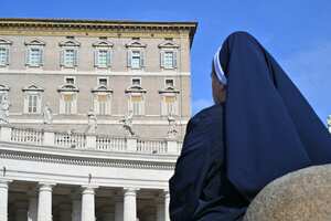 A nun stands in front of the appartments overlooking St Peter's square in The Vatican as Pope Francis is in hospital with pneumonia and will not lead the Angelus prayer, on February 23, 2025. Pope Francis had a quiet night in hospital, the Vatican said on February 23, 2025, the morning after revealing the 88-year-old was in a "critical" condition. "The night passed peacefully, the pope rested," the Holy See said in a short update. (Photo by Andreas SOLARO / AFP)