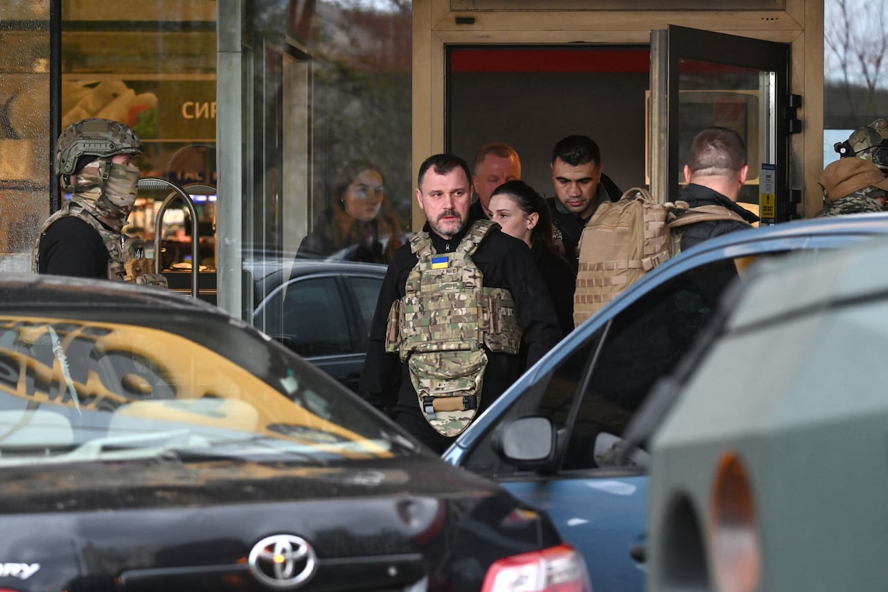 Ukraine's Minister of Internal Affairs Igor Klimenko leaves a supermarket following a shooting in Kyiv on April 18, 2026. A gunman opened fire in Kyiv on April 18, 2026, killing at least five people, wounding others and taking hostages at a supermarket before being killed during an arrest attempt, officials said. Ukrainian President said that at least five people were dead and 10 hospitalised with wounds and trauma after the shooting in a residential district of the capital. (Photo by Sergei SUPINSKY / AFP)