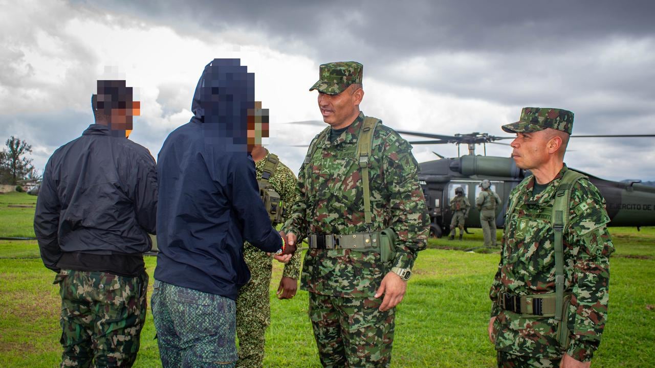Integrantes del Ejército Nacional de Colombia reciben a dos presuntos integrantes del Frente Jaime Martínez que se sometieron voluntariamente a la justicia en zona rural de López de Micay, departamento del Cauca.