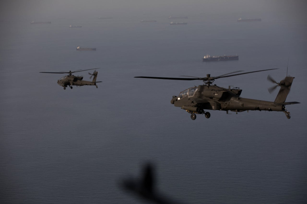 This handout photo released by US Central Command via their X account (@CENTCOM) on April 18, 2026 shows AH-64 Apaches flying above the Strait of Hormuz during a patrol on April 17, 2026. Iran's military declared the Strait of Hormuz closed again on April 18, prompting ships to abandon attempts to transit and President Donald Trump to warn Tehran against trying to "blackmail" the United States. On April 17, Tehran had declared the strait, which usually carries a fifth of the world's oil and liquefied natural gas, open after a ceasefire was agreed in Israel's war with Iran's ally Hezbollah in Lebanon. (Photo by US Central Command (CENTCOM) / AFP) / RESTRICTED TO EDITORIAL USE - MANDATORY CREDIT "AFP PHOTO / US CENTRAL COMMAND " - HANDOUT - NO MARKETING NO ADVERTISING CAMPAIGNS - DISTRIBUTED AS A SERVICE TO CLIENTS