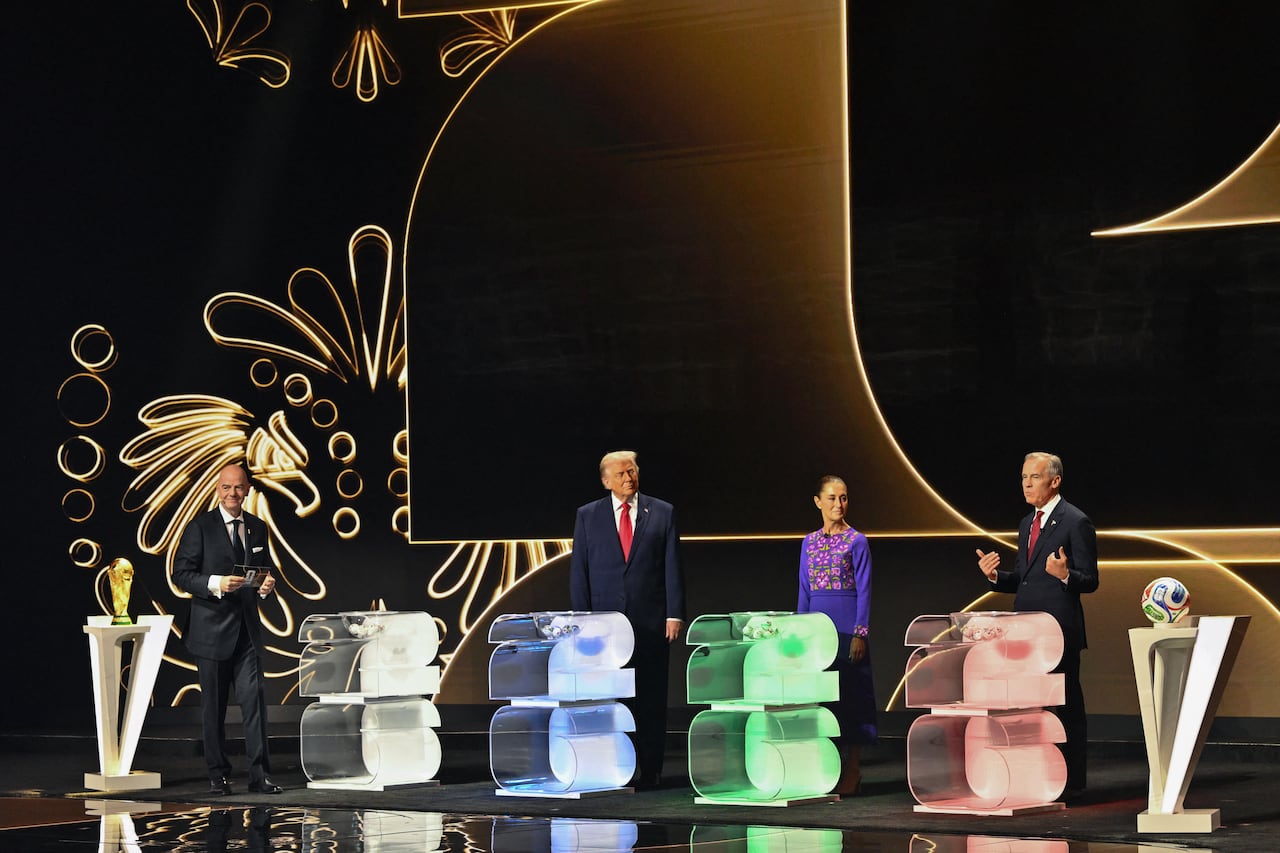 (L/R) FIFA President Gianni Infantino, US President Donald Trump, Mexico's President Claudia Sheinbaum, and Canada's Prime Minister Mark Carney stand on stage during the draw for the 2026 FIFA Football World Cup taking place in the US, Canada and Mexico, at the Kennedy Center, in Washington, DC, on December 5, 2025. (Photo by Mandel NGAN / POOL / AFP)