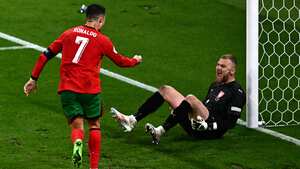 Portugal's forward #07 Cristiano Ronaldo (L) celebrates after Portugal's forward #26 Francisco Conceicao (unseen) scored his team's second goal against Czech Republic's goalkeeper #01 Jindrich Stanek (R) during the UEFA Euro 2024 Group F football match between Portugal and the Czech Republic at the Leipzig Stadium in Leipzig on June 18, 2024. (Photo by GABRIEL BOUYS / AFP)