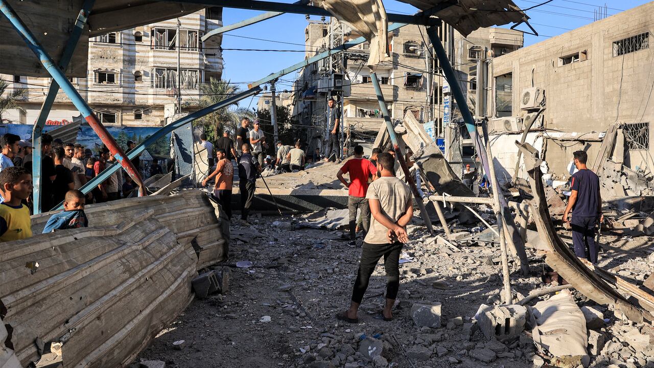 People search the rubble of a collapsed building in the aftermath of Israeli bombardment at the Jaouni school run by the UN Relief and Works Agency for Palestine Refugees (UNRWA) in Nuseirat in the central Gaza Strip on July 6, 2024 amid the ongoing conflict in the Palestinian territory between Israel and Hamas. (Photo by Eyad BABA / AFP)