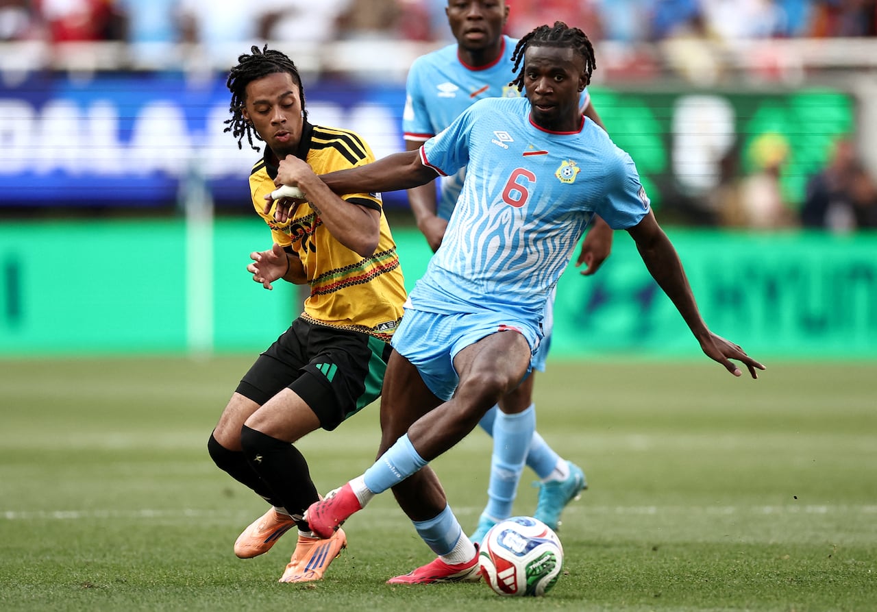 El delantero jamaicano Tyrese Hall (número 21) y el centrocampista de la República Democrática del Congo Ngalayel Mukau (número 6) disputan el balón durante el partido de repechaje de la final de las eliminatorias para la Copa Mundial de la FIFA 2026 entre la República Democrática del Congo y Jamaica en el Estadio Akron de Zapopan, estado de Jalisco, México, el 31 de marzo de 2026. (Foto de Ulises Ruiz / AFP)
