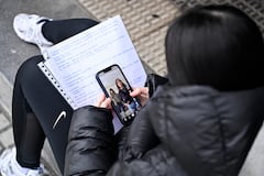 A teenager scrolls through social media on her phone in the Spanish Basque city of San Sebastian on February 4, 2026. Spain will seek to ban social media for under-16s to protect them from harmful content such as pornography and violence, Prime Minister Pedro Sanchez said yesterday, drawing a furious response from X owner Elon Musk. Telegram founder Pavel Durov today joined fellow tech tycoon Elon Musk in slamming Spanish Prime Minister Pedro Sanchez over his "dangerous" plan to ban social media for under-16s. (Photo by ANDER GILLENEA / AFP)