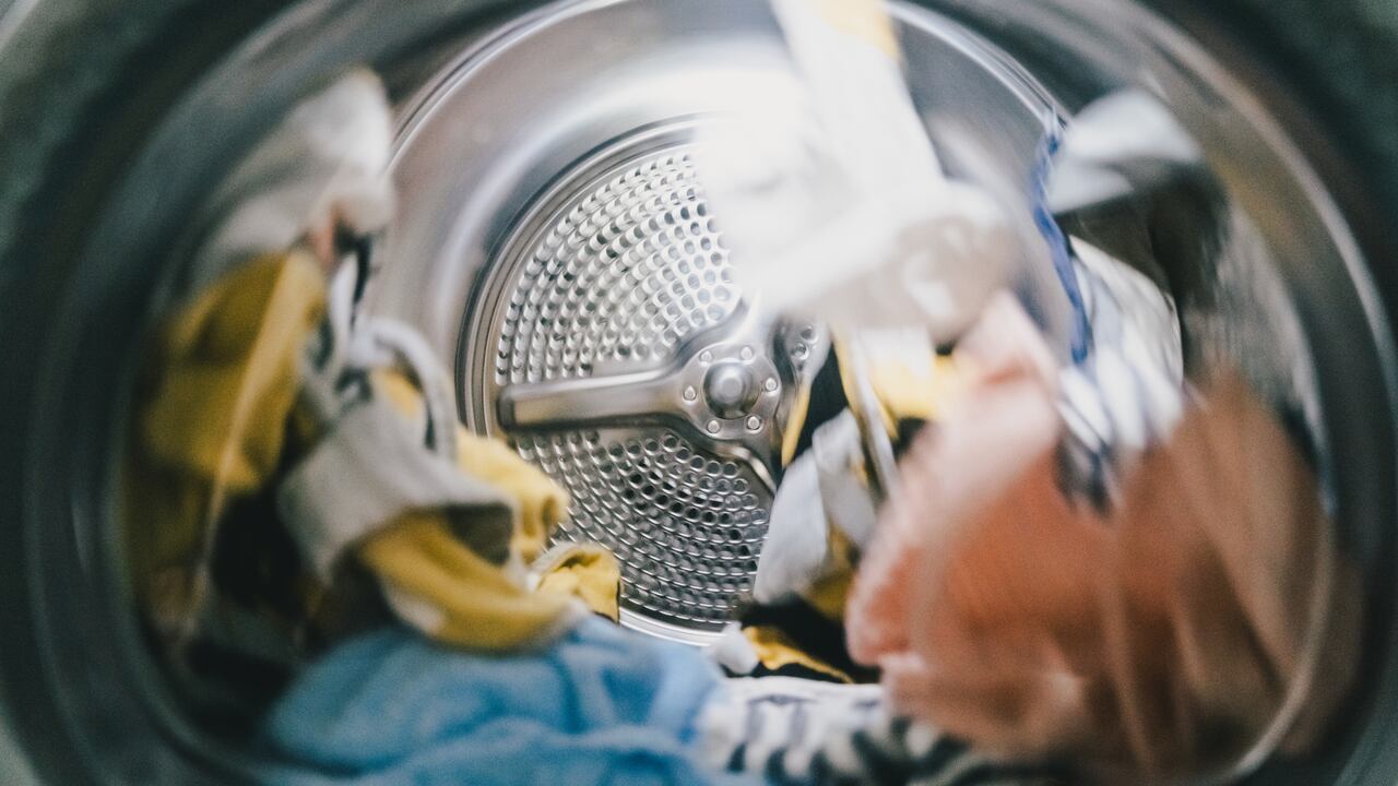 A washing or a drying machine operating, domestic routine and chores concepts. Cleaning with ecological and environmental-friendly detergents and conditioners.