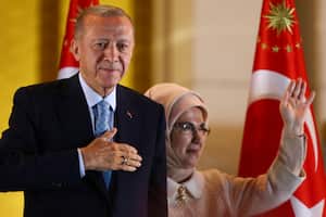 Turkish President and People's Alliance's presidential candidate Recep Tayyip Erdogan, left, and his wife, Emine, gesture to supporters at the presidential palace, in Ankara, Turkey, Sunday, May 28, 2023. Turkey President Recep Tayyip Erdogan won reelection Sunday, extending his increasingly authoritarian rule into a third decade as the country reels from high inflation and the aftermath of an earthquake that leveled entire cities. (AP Photo/Ali Unal)