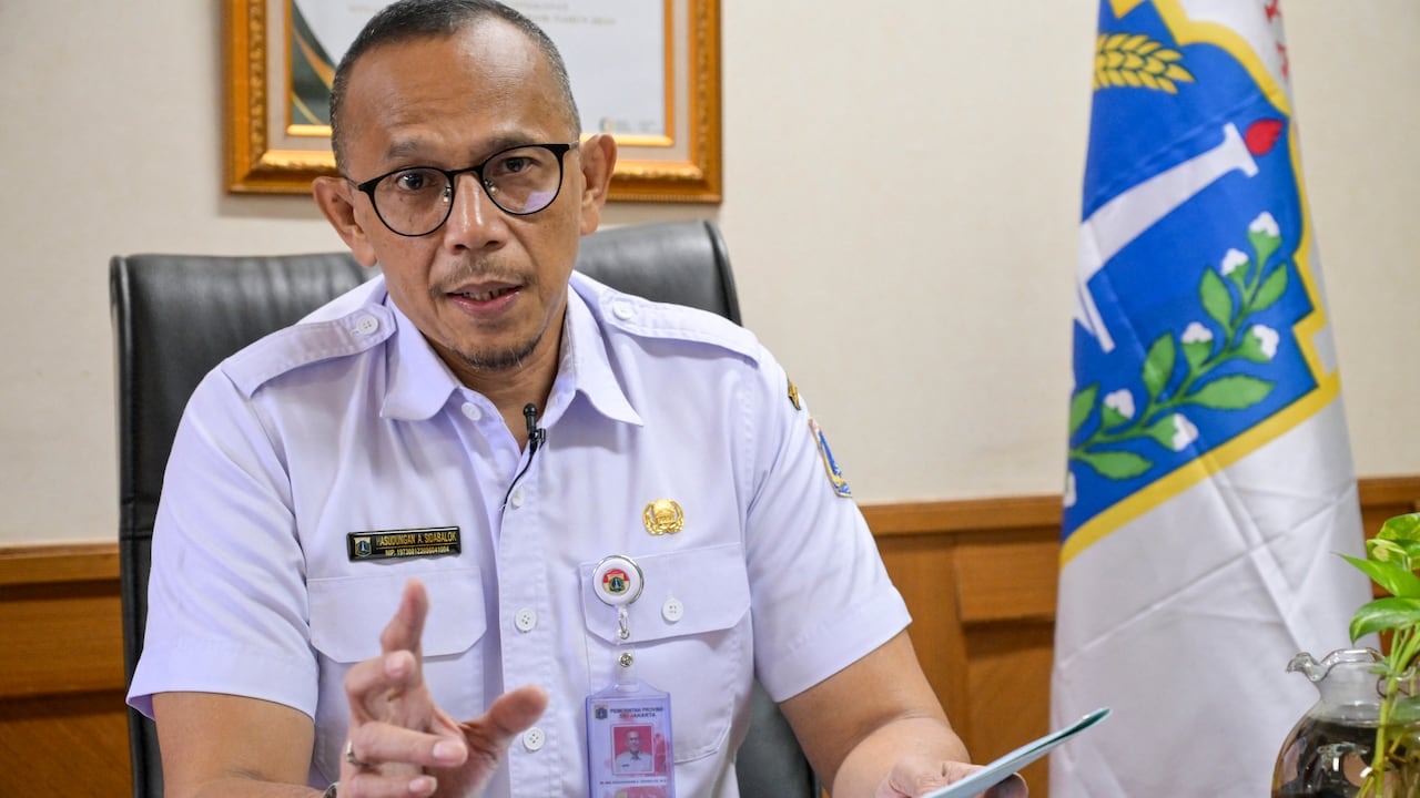 Hasudungan A. Sidabalok, head of Jakarta's food resiliency, maritime and agriculture agency (DKPKP), answers AFP's questions during an interview in Jakarta on November 26, 2025. This week, Jakarta's authorities announced a ban in the capital on trade for the consumption of rabies-transmitting animals, including cats and dogs. The prohibition, with a six-month grace period before enforcement begins, was hailed by animals rights groups who have long lobbied against the trade. (Photo by BAY ISMOYO / AFP) / TO GO WITH 'INDONESIA-ANIMAL-LAW-HEALTH-FOOD-DRINK, REPORTAGE' BY MARCHIO GORBIANO