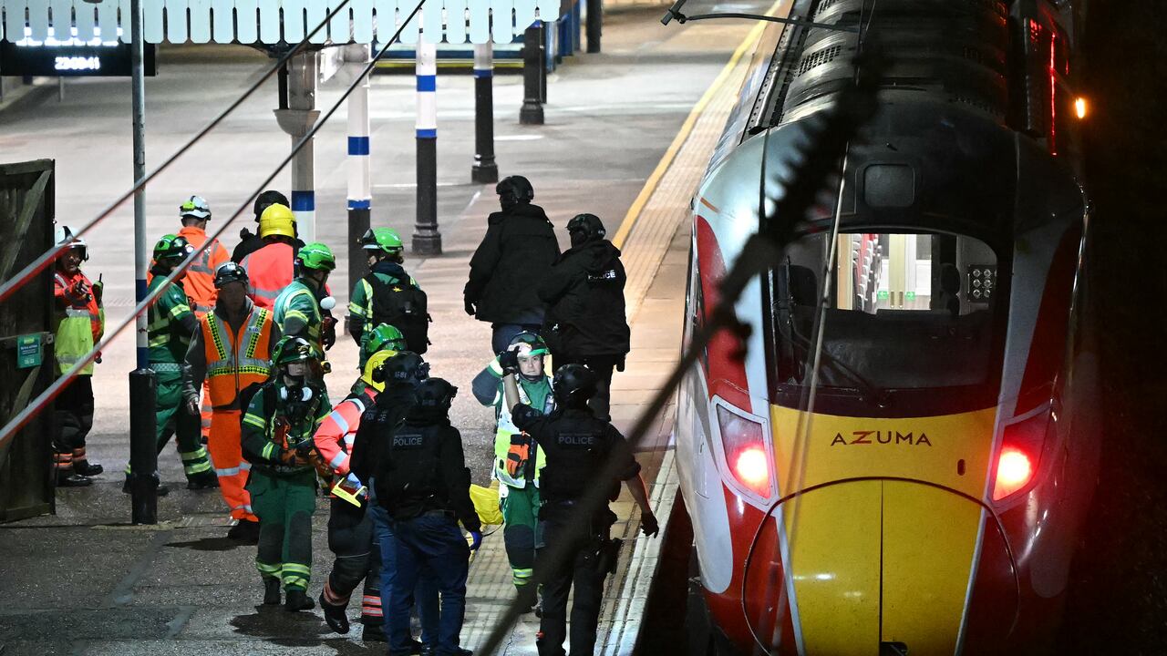 Police officers and members of the Emergency services work alongside an LNER Azuma train at Huntingdon Station in Huntingdon, eastern England, on November 1, 2025, following a stabbing on a train. UK police said they had arrested two suspects Saturday as "a number of people" were taken to hospital after a stabbing on a train in Cambridgeshire, eastern England. "We are currently responding to an incident on a train to Huntingdon where multiple people have been stabbed," British Transport Police said on X, adding that "two people have been arrested". (Photo by JUSTIN TALLIS / AFP)