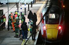 Police officers and members of the Emergency services work alongside an LNER Azuma train at Huntingdon Station in Huntingdon, eastern England, on November 1, 2025, following a stabbing on a train. UK police said they had arrested two suspects Saturday as "a number of people" were taken to hospital after a stabbing on a train in Cambridgeshire, eastern England. "We are currently responding to an incident on a train to Huntingdon where multiple people have been stabbed," British Transport Police said on X, adding that "two people have been arrested". (Photo by JUSTIN TALLIS / AFP)