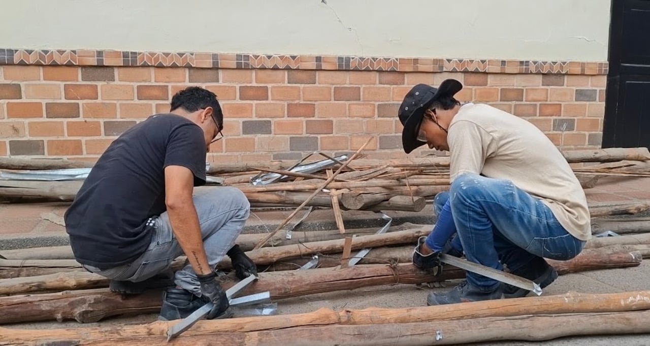 Vecinos y voluntarios se turnan las herramientas para acelerar la limpieza de una vivienda afectada.
