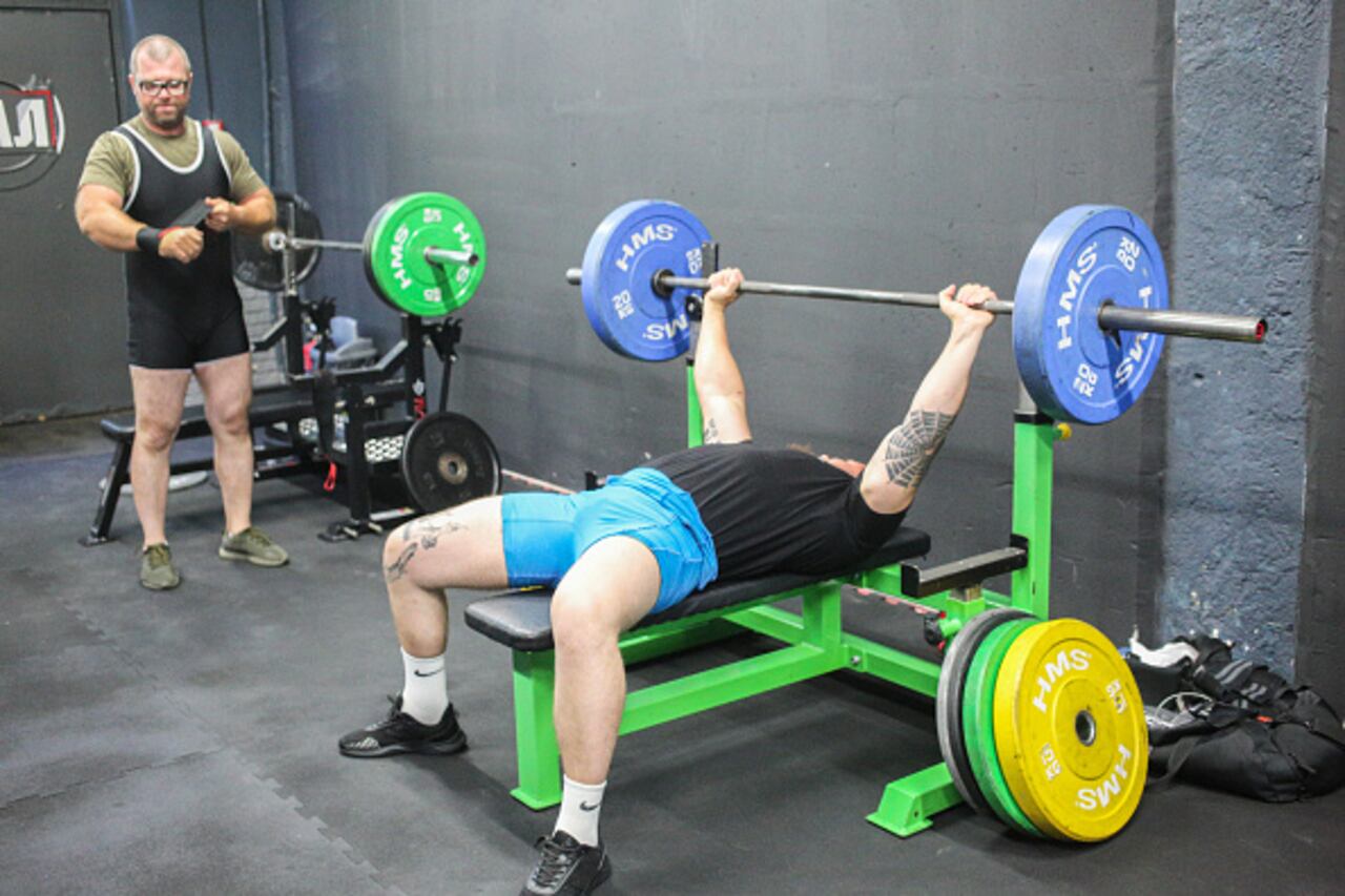 ODESA, UKRAINE – AUGUST 6: A participant performs a bench press during a powerlifting competition on August 6, 2023 in Odesa, Ukraine. As part of the Black Sea Cup, a charity powerlifting tournament was held in Odesa to honor Ihor "Fast" Balmagiya, a fallen soldier of the Armed Forces Of Ukraine. During his life, Ihor dreamed of becoming a coach and carrying knowledge. In this way, his comrades honor his memory. (Photo by Viacheslav Onyshchenko/Global Images Ukraine via Getty Images)