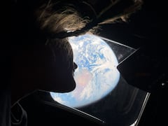 This handout picture by an Artemis II crew member provided by NASA shows Artemis II mission specialist Christina Koch looking back at earth through the window of the Orion spacecraft on April 2, 2026. The four Artemis astronauts have passed the halfway point between Earth and the Moon on the way to their planned lunar flyby, NASA said on April 3. "You are now closer to the moon than you are to us on Earth," mission control told the astronauts at around 11 pm (0400 GMT), according to the space agency's official live broadcast. (Photo by Handout / NASA / AFP) / RESTRICTED TO EDITORIAL USE - MANDATORY CREDIT "AFP PHOTO / NASA" - HANDOUT - NO MARKETING NO ADVERTISING CAMPAIGNS - DISTRIBUTED AS A SERVICE TO CLIENTS