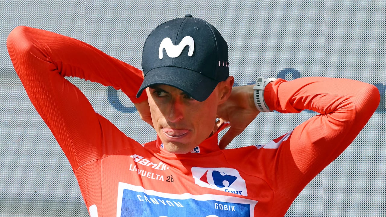 Team Movistar's Spanish rider Enric Mas puts on the overall leader's red jersey on the podium after the 10th stage of the Vuelta a Espana 2026 cycling tour, a 184,7 km race between Alcaraz and Elche de la Sierra, on September 1, 2026. (Photo by JOSE JORDAN / AFP)