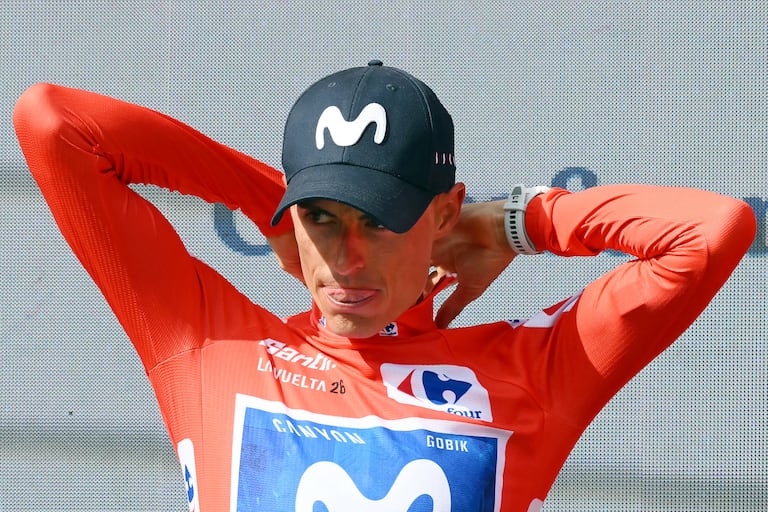 Team Movistar's Spanish rider Enric Mas puts on the overall leader's red jersey on the podium after the 10th stage of the Vuelta a Espana 2026 cycling tour, a 184,7 km race between Alcaraz and Elche de la Sierra, on September 1, 2026. (Photo by JOSE JORDAN / AFP)