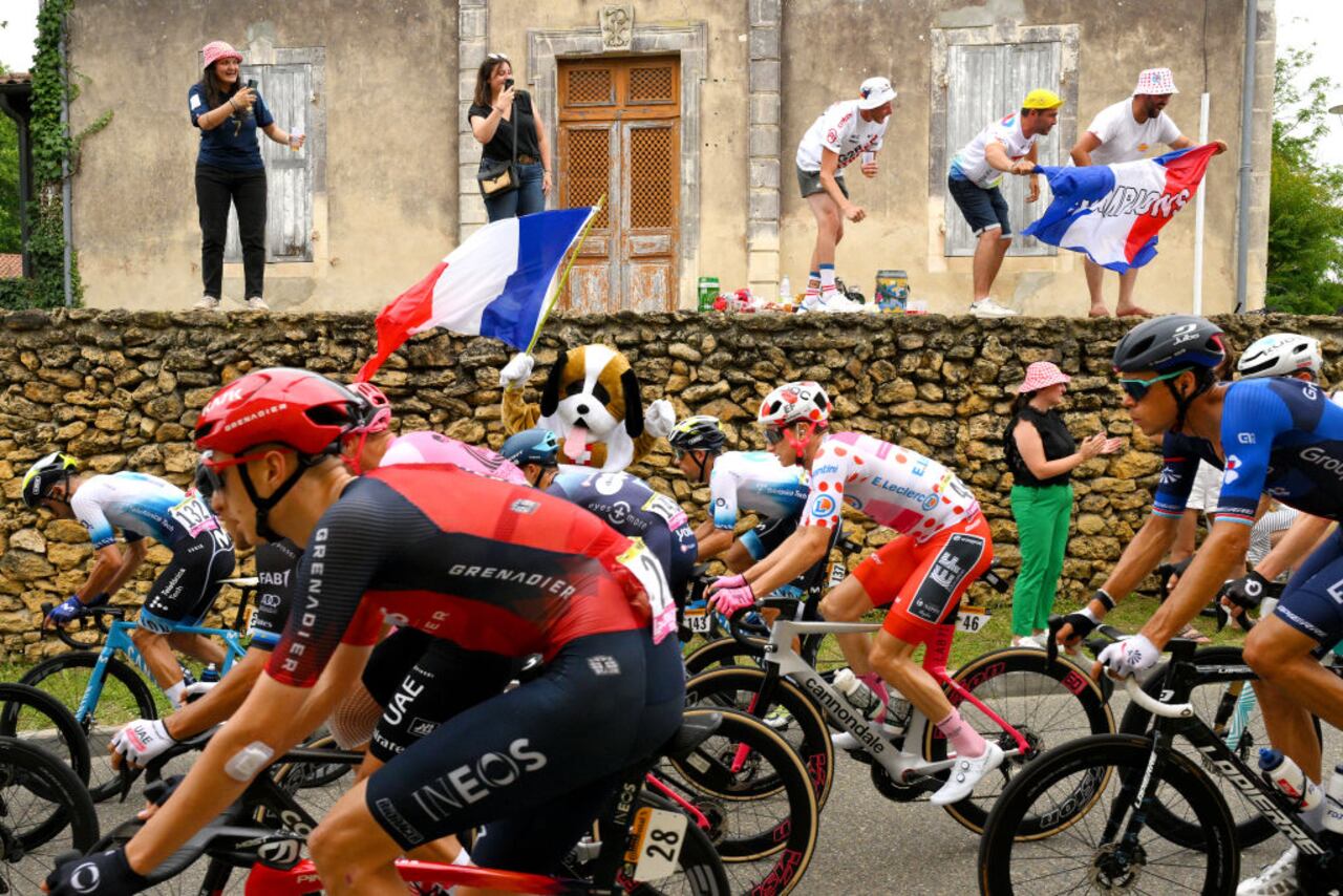 NOGARO, FRANCE - JULY 04: Neilson Powless of The United States and Team EF Education-EasyPost - Polka Dot Mountain Jersey and a general view of the peloton competing while fans cheer during the stage four of the 110th Tour de France 2023 a 181.8km stage from Dax to Nogaro / #UCIWT / on July 04, 2023 in Nogaro, France. (Photo by David Ramos/Getty Images)