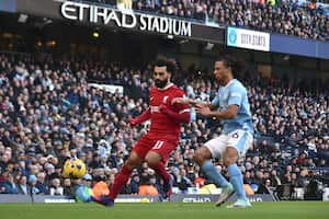 Liverpool's Mohamed Salah, left, challenges for the ball with Manchester City's Nathan Ake during the English Premier League soccer match between Manchester City and Liverpool at Etihad stadium in Manchester, England, Saturday, Nov. 25, 2023. (AP Photo/Rui Vieira)