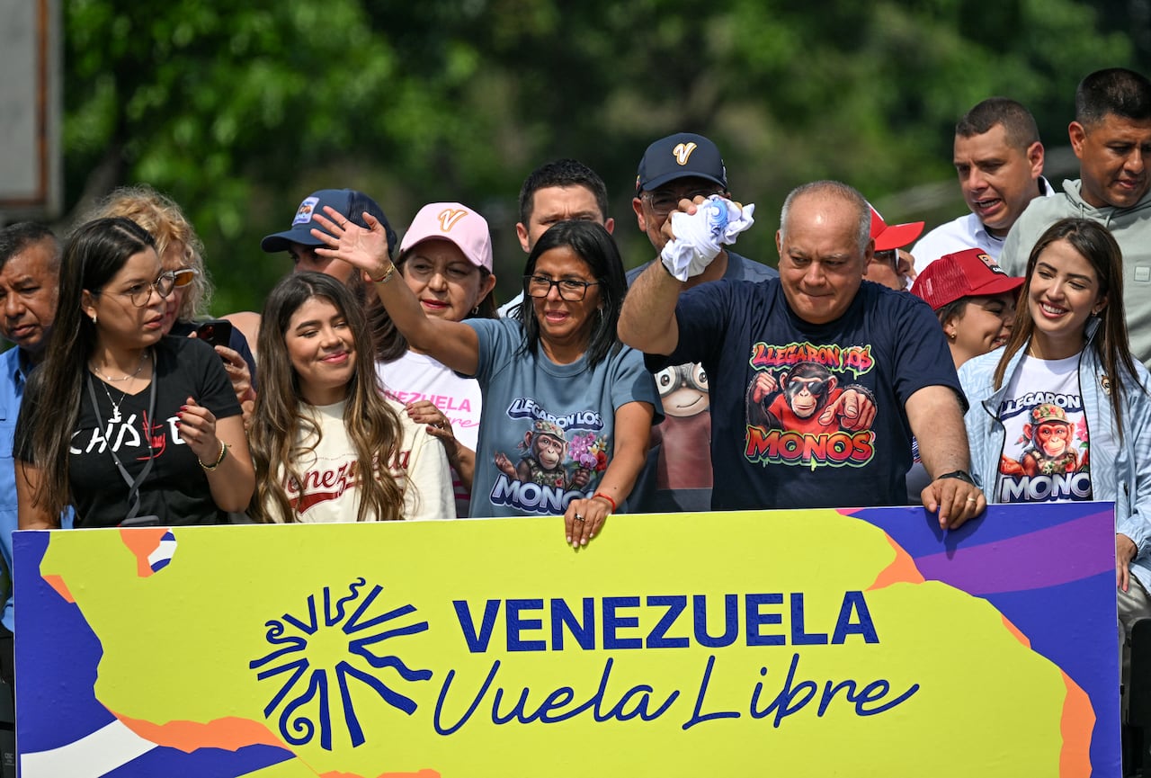 Venezuela's acting president Delcy Rodriguez (C) gestures next to Interior Minister Diosdado Cabello (2nd R) during a march calling for the lifting of all US sanctions in Caracas on April 30, 2026. Delcy Rodriguez announced on April 30 a 26% wage increase to the so-called "integral minimum income," raising it from 190 dollars to 240 dollars per month, the first adjustment since Nicolas Maduro's fall. (Photo by Juan BARRETO / AFP)