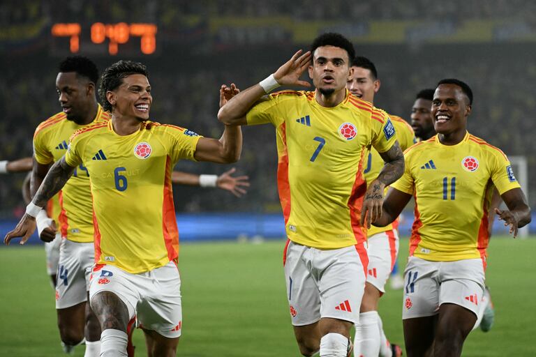 Colombia's forward #07 Luis Diaz (2nd-R) celebrates with teammates midfielder #06 Richard Rios and forward #11 Jhon Arias after scoring his team first goal during the 2026 FIFA World Cup South American qualifiers football match between Colombia and Paraguay at the Metropolitano Roberto Melendez stadium in Barranquilla, Colombia, on March 25, 2025. (Photo by Luis ACOSTA / AFP)