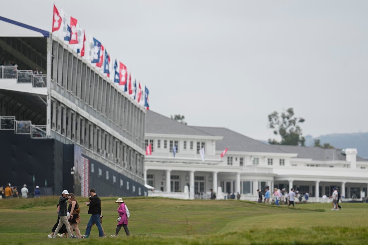 Los fanáticos caminan en el primer hoyo durante una ronda de práctica para el torneo de golf del Campeonato U.S Open en Los Angeles Country Club el miércoles, 14 de junio de 2023, en Los Ángeles. (Foto AP/George Walker IV)