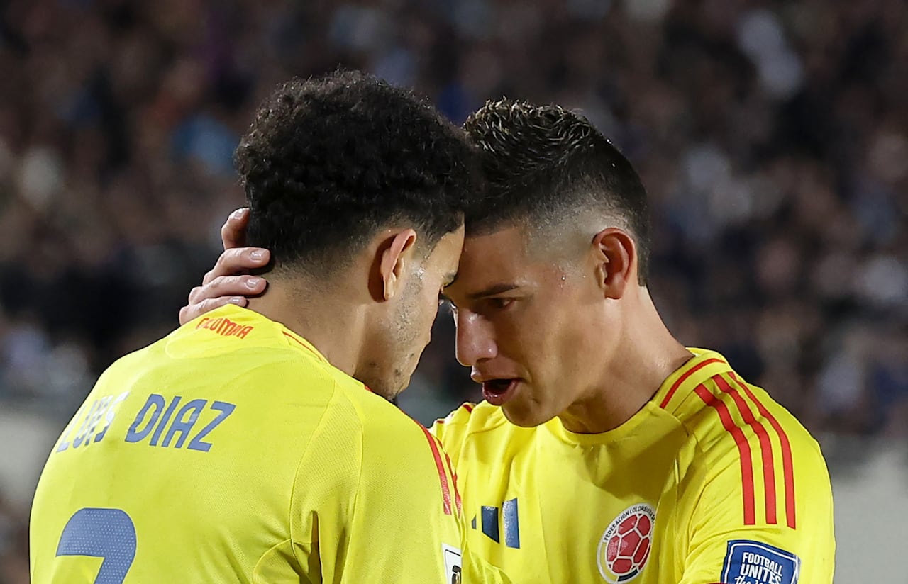 Colombia's forward #07 Luis Diaz celebrates with teammate midfielder #10 James Rodriguez after scoring his team's first goal during the 2026 FIFA World Cup South American qualifiers football match between Argentina and Colombia at the Mas Monumental stadium in Buenos Aires, on June 10, 2025. (Photo by Alejandro PAGNI / AFP)