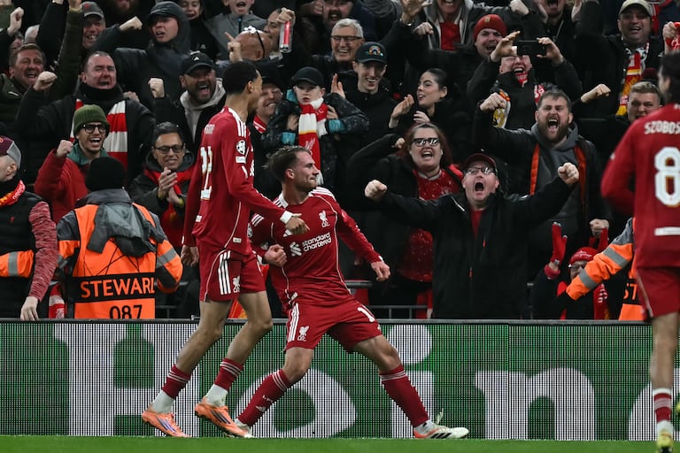 Liverpool's Argentinian midfielder #10 Alexis Mac Allister (C) celebrates after scoring the opening goal of the UEFA Champions League, league phase football match between Liverpool and Real Madrid at Anfield in Liverpool, north west England on November 4, 2025. (Photo by Paul ELLIS / AFP)