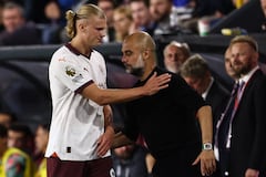 Haaland se saluda con su entrenador, Pep Guardiola tras salir del partido del Manchester City