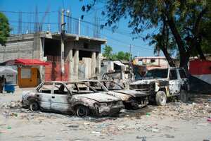 Charred vehicles remain parked as gang violence escalates in Port-au-Prince, Haiti, on March 9, 2024. Sporadic gunfire rang out in Port-au-Prince late March 8, an AFP correspondent there heard, as residents desperately sought shelter amid the recent explosion of gang violence in the Haitian capital. (Photo by Clarens SIFFROY / AFP)