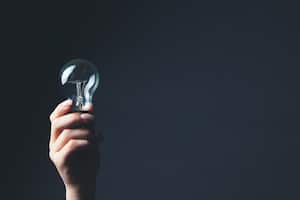 a woman's hand holding a light bulb