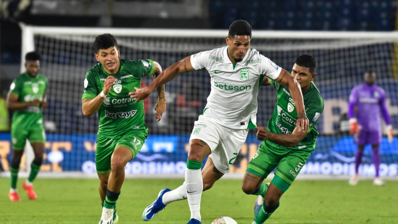 Atletico Nacional's Eric Ramirez (C) fights the ball against Equidad's Elan Joshep Ricardo Ochoa (L) and Martin Payares (R) during the BetPlay Dimayor Leagua match between Equidad (2) and Nacional (0) in Bogota, Colombia's El Campin stadium on February 25, 2024. (Photo by: Cristian Bayona/Long Visual Press/Universal Images Group via Getty Images)