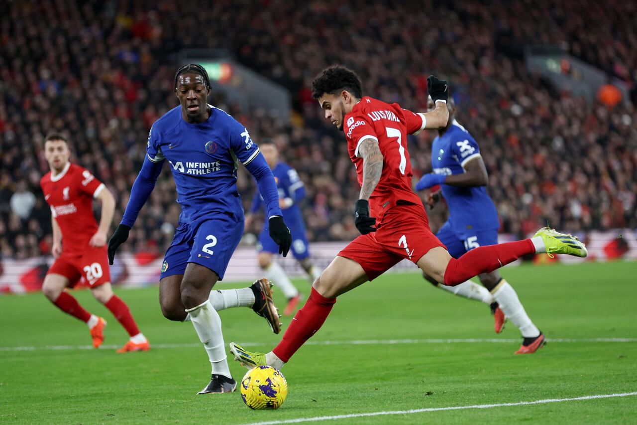 LIVERPOOL, ENGLAND - JANUARY 31: Luis Diaz of Liverpool shoots whilst under pressure from Axel Disasi of Chelsea during the Premier League match between Liverpool FC and Chelsea FC at Anfield on January 31, 2024 in Liverpool, England. (Photo by Clive Brunskill/Getty Images)