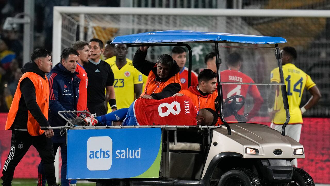 Chile's Arturo Vidal is taken out the field injured during a qualifying soccer match against Colombia for the FIFA World Cup 2026 at Monumental stadium in Santiago, Chile, Tuesday, Sept. 12, 2023. (AP Photo/Esteban Felix)