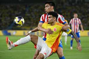 El delantero de Colombia, Luis Díaz, intenta sostener el balón, ante la marca del volante, Diego Gómez, en partido de las Eliminatorias Sudamericana 2026, en Barranquilla. (Foto Luis ACOSTA / AFP)