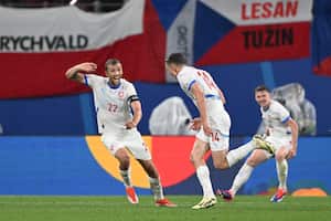 Czech Republic's midfielder #14 Lukas Provod (C) celebrates with Czech Republic's midfielder #22 Tomas Soucek (L) after scoring his team's first goal during the UEFA Euro 2024 Group F football match between Portugal and the Czech Republic at the Leipzig Stadium in Leipzig on June 18, 2024. (Photo by PATRICIA DE MELO MOREIRA / AFP)