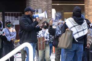 NEW YORK, NEW YORK - APRIL 22: A security guard gives a warning to New York University students as they set up a "Liberated Zone" tent encampment in Gould Plaza at NYU Stern School of Business on April 22, 2024 in New York City. NYU students joined the growing number of students in colleges throughout the country to set up tent encampments on school grounds calling on their schools to divest from Israel and a ceasefire in Gaza. Nearly 50 people were arrested at Yale on Monday morning after the arrest last week of more than 100 protesters at Columbia University. Michael M. Santiago/Getty Images/AFP (Photo by Michael M. Santiago / GETTY IMAGES NORTH AMERICA / Getty Images via AFP)