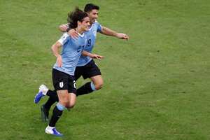 Edison Cavani es felicitado por Luis Suárez después de conseguir el gol del triunfo sobre Chile.