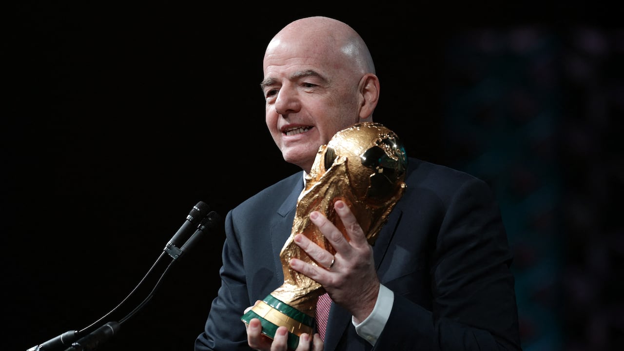 WASHINGTON, DC - JANUARY 29: FIFA President Gianni Infantino holds the FIFA World Cup Trophy as he addresses the winter meeting of The U.S. Conference of Mayors on January 29, 2026 in Washington, DC. Infantino promoted the 2026 FIFA World Cup, which will be co-hosted by the United States, Canada, and Mexico, highlighting its potential benefits for host cities and communities. Alex Wong/Getty Images/AFP (Photo by ALEX WONG / GETTY IMAGES NORTH AMERICA / Getty Images via AFP)