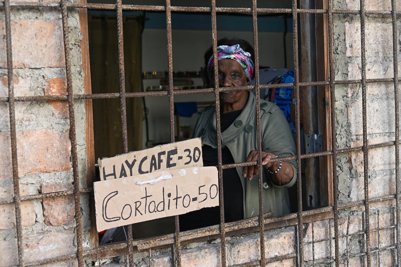A woman sells coffee in her home in Havana on February 18, 2026. US Secretary of State Marco Rubio has held secret talks with a scion of Cuba's communist Castro leadership as he intensifies pressure on the island, a report said. Axios, quoting unnamed sources, said Rubio has been speaking with Raul Guillermo Rodriguez, the grandson of former leader Raul Castro, who succeeded his brother Fidel Castro. (Photo by YAMIL LAGE / AFP)