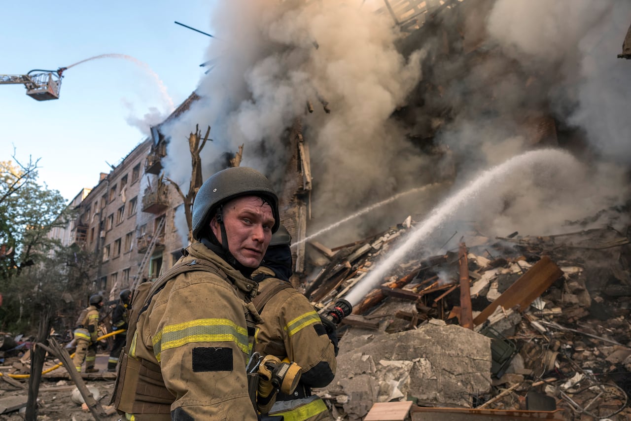 Firefighters work to extinguish a fire at the site of a heavily damaged building following Russian strikes to the Ukrainian capital in Kyiv on May 24, 2026, amid the Russian invasion of Ukraine. A large ballistic missile attack pounded Kyiv early on Sunday, authorities said, wounding at least five people after Moscow threatened retaliation for strikes in Russian-occupied eastern Ukraine. (Photo by Vladyslav MUSIENKO / AFP)