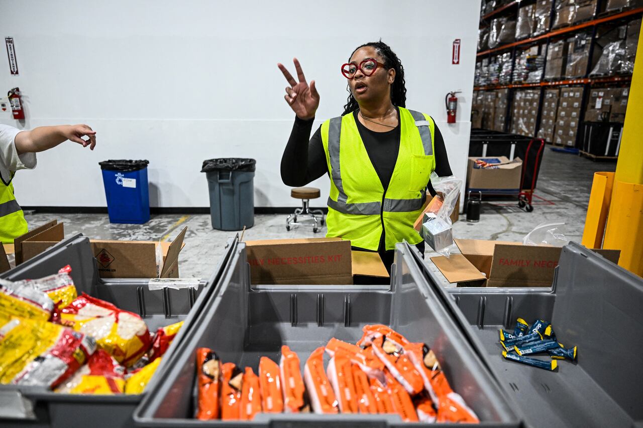 Volunteers assemble relief packages for Hurricane Melissa at the Global Empowerment Mission headquarters in Miami, Florida, on October 27, 2024. Hurricane Melissa threatened Jamaica with potentially deadly rains after rapidly intensifying into a top-level Category 5 storm, as residents scrambled for shelter from what could be the island's most violent weather on record. Melissa has already been blamed for at least four deaths in Haiti and the Dominican Republic, and was set to unleash torrential rains on parts of Jamaica in a direct hit on the Caribbean island. (Photo by CHANDAN KHANNA / AFP)