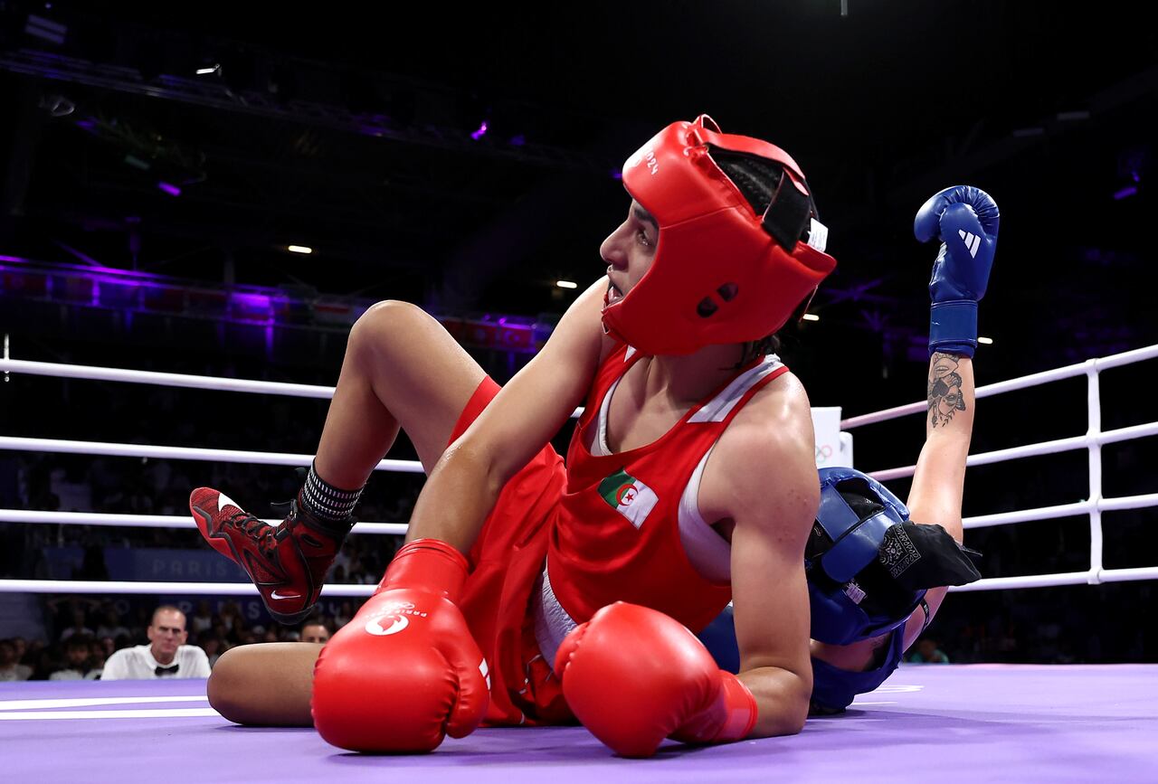 PARIS, FRANCE - AUGUST 03: Imane Khelif of Team Algeria falls over Anna Luca Hamori of Team Hungary during the Women's 66kg Quarter-final round match on day eight of the Olympic Games Paris 2024 at North Paris Arena on August 03, 2024 in Paris, France. (Photo by Richard Pelham/Getty Images)