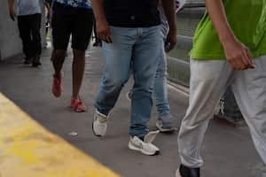 Migrants walk back to Mexico through the Gateway International Port of Entry in Brownsville, Texas, Friday, May 5, 2023, after being sent back due to Title 42. Migrants have been expelled from the U.S. more than 2.8 million times since March 2020 under what is known as Title 42 authority. (AP Photo/Veronica G. Cardenas)