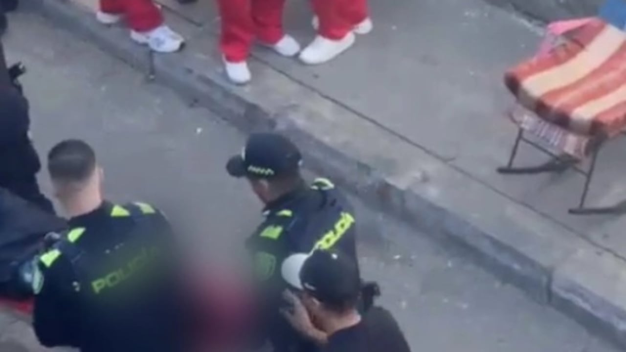 Autoridades de policía y organismos de socorro atienden la situación de orden público a las afueras de la institución educativa en Medellín.