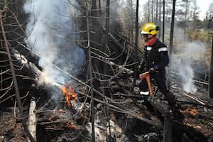 This July 2, 2023, image released by the French General Directorate for Civil Protection and Crisis Management (DGSCGC) shows a French firefighter battling wildfires in the Abitibi-T�miscamingue region of Quebec, more than 650kms (400 miles) north of Montreal. A record 22.7 million acres (9.2 million hectares) have burned so far by wildfires raging across Canada, according to the Canadian Interagency Forest Fire Centre on July 10, 2023. (Photo by Carlo ZAGLIA / General Directorate for Civil Protection and Crisis Management / AFP) / RESTRICTED TO EDITORIAL USE - MANDATORY CREDIT "AFP PHOTO / Carlo ZAGLIA/DGSCGC" - NO MARKETING NO ADVERTISING CAMPAIGNS - DISTRIBUTED AS A SERVICE TO CLIENTS