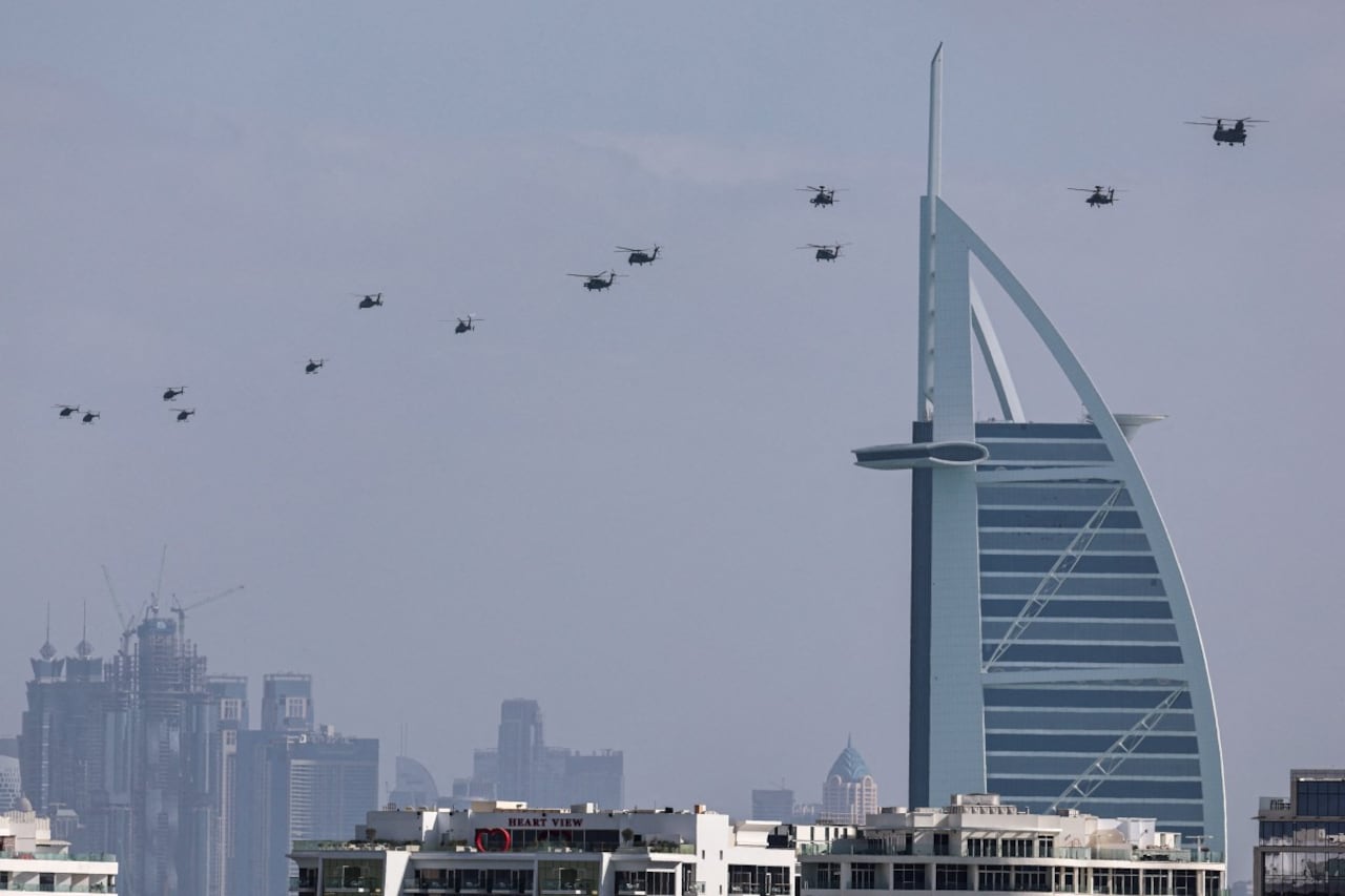 Helicópteros del ejército de los Emiratos Árabes Unidos sobrevuelan el hotel Burj al Arab, en Dubai, el 16 de enero de 2026. (Foto de Fadel SENNA / AFP)