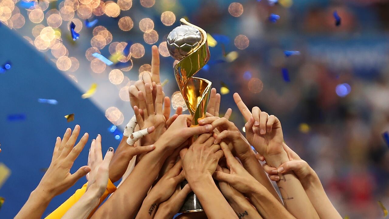 ILE - In this July 7, 2019, file photo, the United States players hold the trophy as they celebrate winning the Women's World Cup final soccer match against The Netherlands at the Stade de Lyon in Decines, outside Lyon, France. The 2023 Women's World Cup will be spread across nine cities in Australia and New Zealand. (AP Photo/Francisco Seco, File)