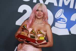 SEVILLE, SPAIN - NOVEMBER 16: Karol G poses with the awards for Best Recording of the Year, Best Urban Album of the Year, and Best Album of the Year in the media center for The 24th Annual Latin Grammy Awards at FIBES Conference and Exhibition Centre on November 16, 2023 in Seville, Spain. (Photo by Patricia J. Garcinuno/WireImage)